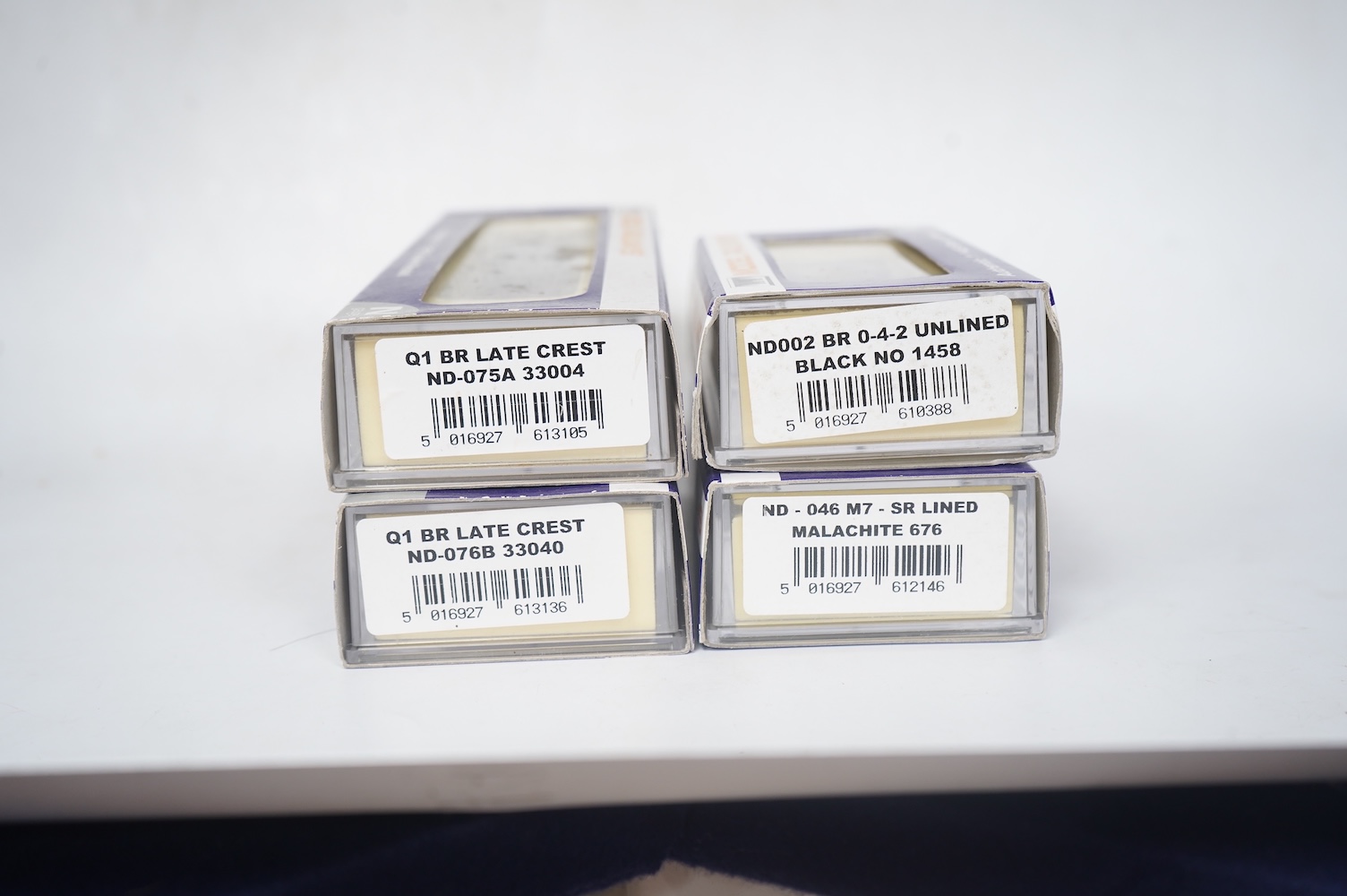 Four boxed Dapol N gauge railway locomotives; two BR Class Q1, both 33040 (ND-076B), one in associated box, a BR Class 14xx, 1458 (ND002) and an SR Class M7, 676 (ND-046). Condition - good.